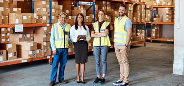 Four team members in a warehouse